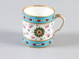 a coffee cup with a floral design on it