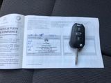a car key sitting on top of a piece of paper next to a car key