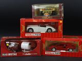 three boxed boxes of toy cars on a black surface