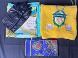 a yellow towel, a black glove, and a passport on a black surface