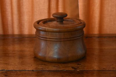 a wooden container with a lid on a wooden table