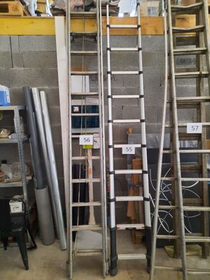 many ladders that are stacked up in a room