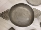 a pan that is sitting on a table next to other pots and pans