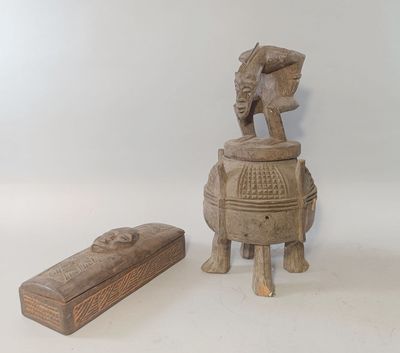 a small wooden box with a statue on it next to a small wooden box