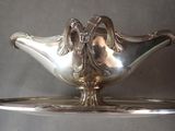a silver plate with a bird on top of it
