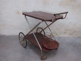 a wooden cart with two wine glasses on top of it