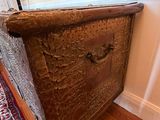 a wooden chest sitting in the corner of a room