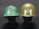 pair of green and green hard hats sitting on top of a mannequin head