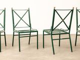 three green metal chairs sitting next to each other on a cement floor