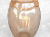 a glass vase that is sitting on a table