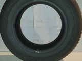 tire of a truck on a white surface with a white wall in the background