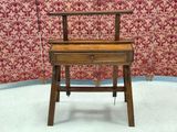 a small wooden desk with a drawer underneath it