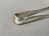 a silver spoon and spoon rest on a table