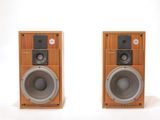 two speakers sitting next to each other on a white surface