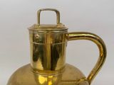 a gold teapot with a handle on a white background