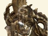 a statue of a woman holding a bird on top of a table