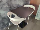 two chairs and a table in the corner of a room