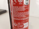 a red fire extinguisor sitting on a table