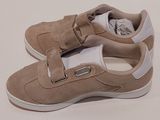 the shoes are tan and white with a buckle on each side