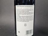 bottle of red wine on a table with a barcode on the label