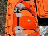 two life jackets and a life vest on the ground