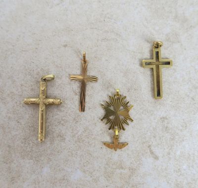 three gold crosses and a cross with a sun in the middle