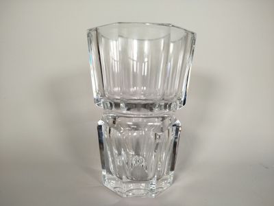 a clear glass vase sitting on top of a white table