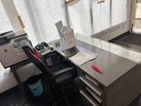 a desk with a chair and a printer on it