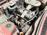 an old car engine with the hood open