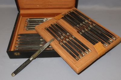 a wooden box with a set of knives in it