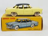 yellow and blue toy car sitting on top of a yellow box