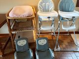 two baby high chairs and a baby chair in the room