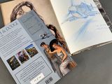an open book with a drawing of a woman in a white dress