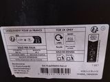 a close up of a label on the back of a black refrigerator