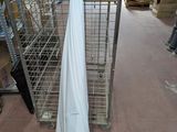 a white cloth hanging on a rack in a warehouse