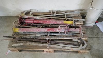 a pile of tools sitting on a pallet in a room