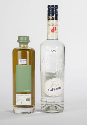 deux bouteilles d'alcool posées l'une à côté de l'autre sur une table