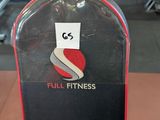 a black and red snowboard sitting on the floor in a gym