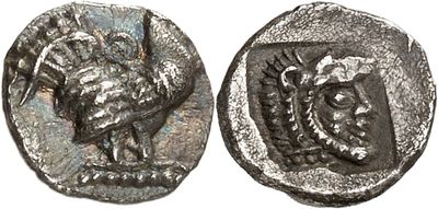 a close up of a coin with a bird on it