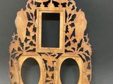 a wooden clock with a mirror on the top of it