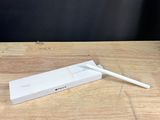 a white toothbrush sitting on top of a wooden table