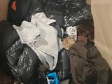 a cardboard box filled with clothes and other items