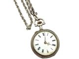 a silver pocket watch with roman numerals on it