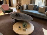 a living room with a couch, chair, coffee table, and piano in it