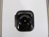 a black apple watch sitting on a white table