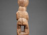 a stone statue of a woman holding a child
