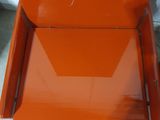 an orange chair sitting on top of a white floor next to a wall
