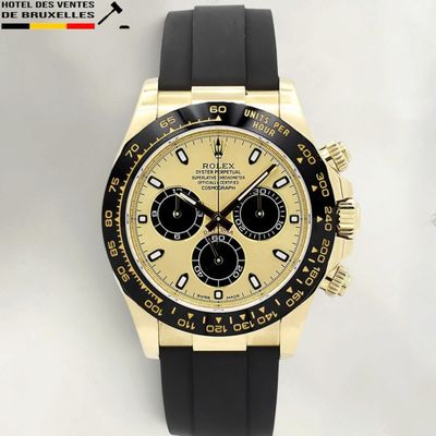the watch is gold and black with a black face