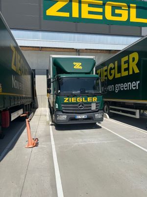 two semi trucks that are parked in a parking lot