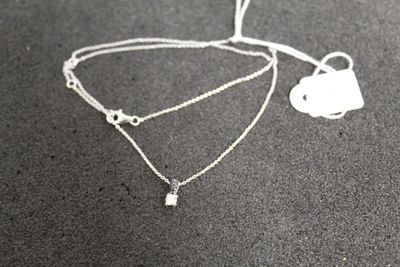 a necklace that has a heart and a key on it